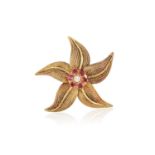 A RUBY AND DIAMOND FLOWER BROOCH, BY REGNER, CIRCA 1960 Designed as a stylised flowerhead, the