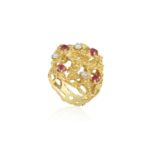 A RUBY AND DIAMOOND COCKTAIL RING BY WEST, CIRCA 1970 Of openwork abstract domed design, the