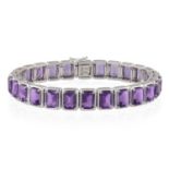 AN AMETHYST BRACELET Composed of a line of rectangular-cut amethysts within four-claw setting,