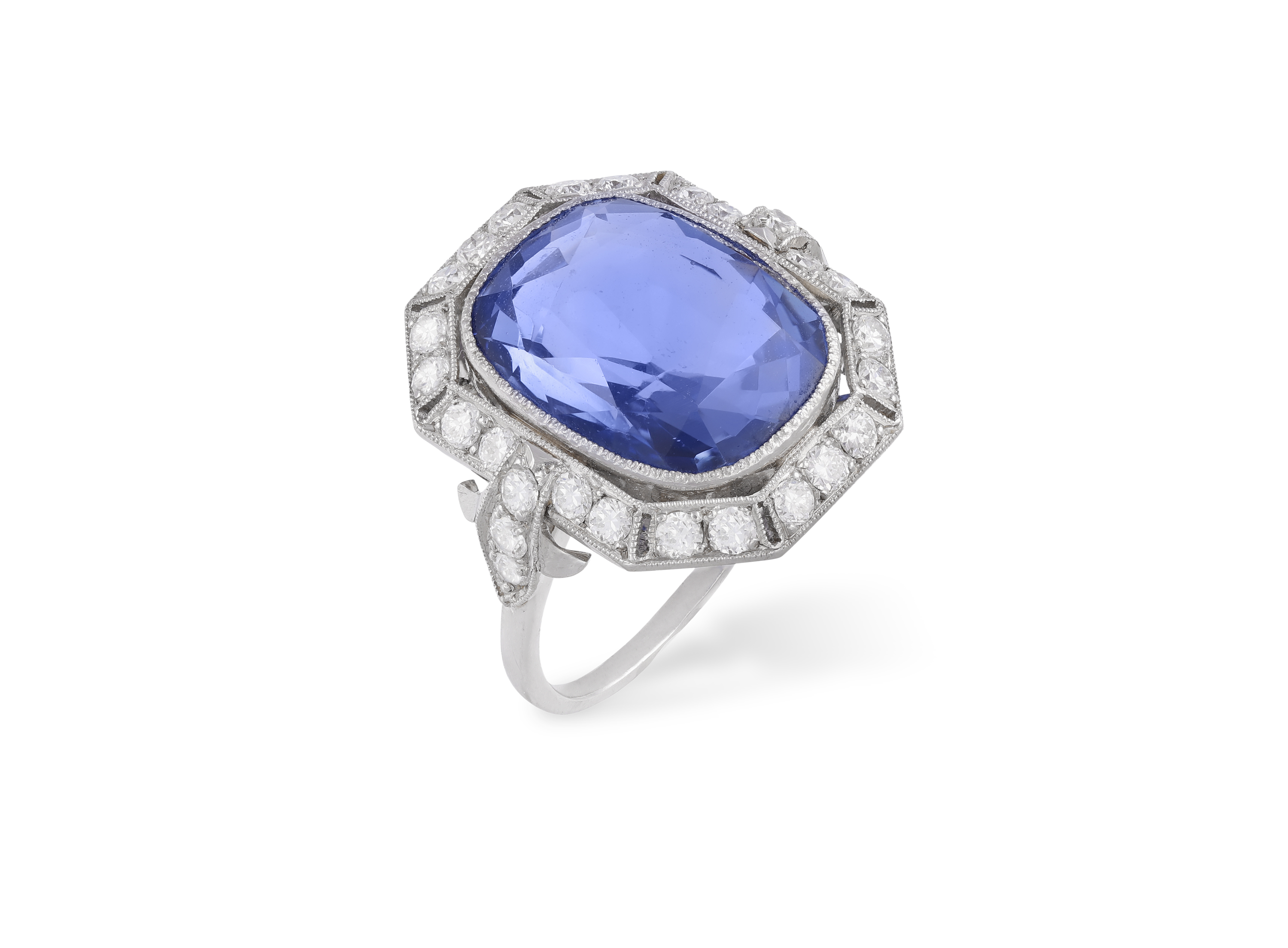 AN EARLY 20TH CENTURY SAPPHIRE AND DIAMOND RING The cushion-shaped sapphire weighing approximately