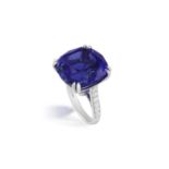 AN IMPRESSIVE TANZANITE AND DIAMOND DRESS RING The cushion-shaped tanzanite weighing 27.12cts within