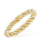 A GOLD AND CULTURED PEARL TORSADE BRACELET Composed of gold entwined strands with ropetwist detail