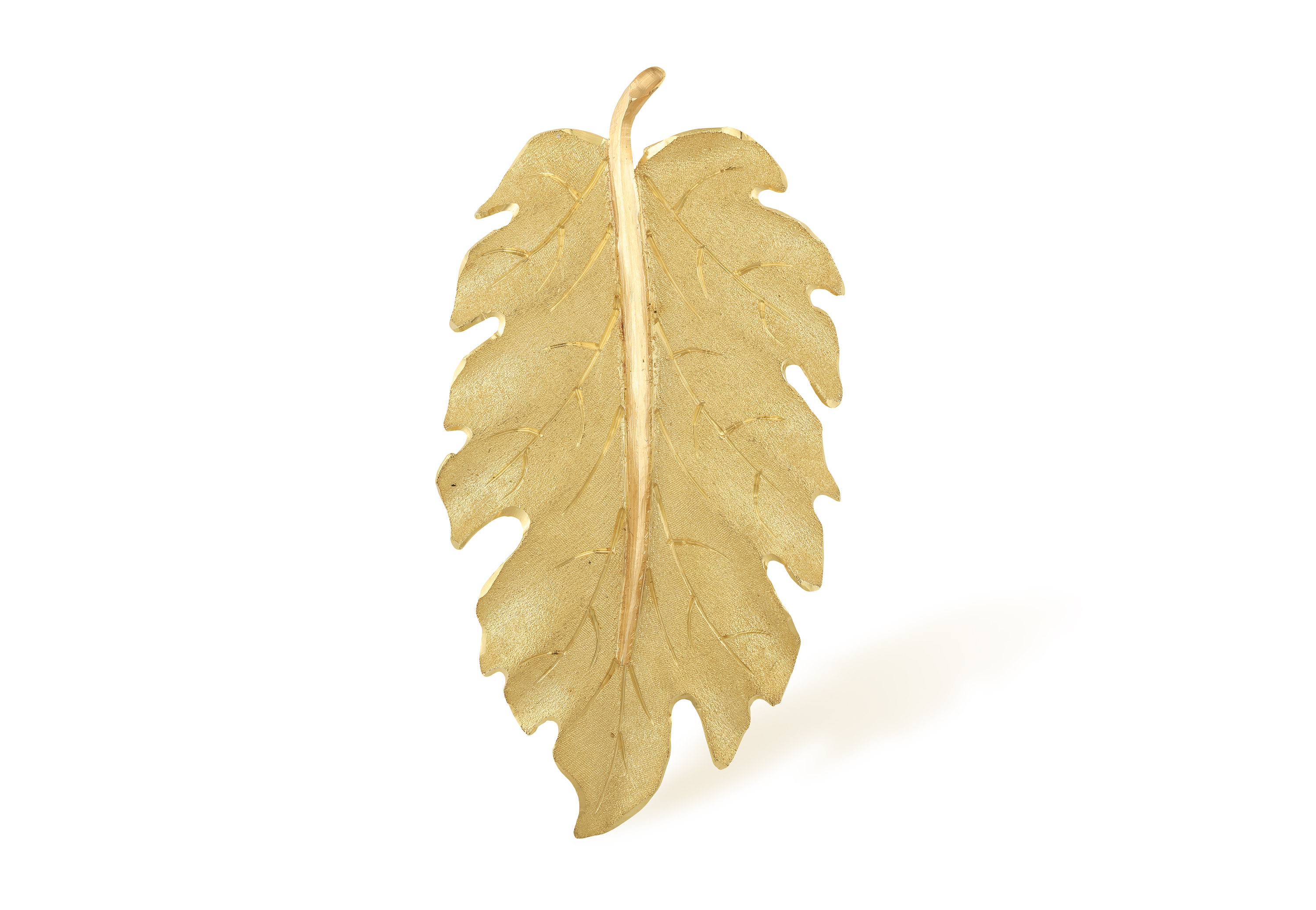 A GOLD 'FOGLIA' BROOCH, BY BUCCELLATI Designed as a delicate textured gold leaf, in 18K gold, signed