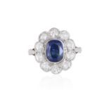 A SAPPHIRE AND DIAMOND CLUSTER RING The cushion-shaped sapphire collet-set at the centre, within a
