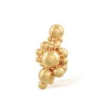A GOLD BROOCH Of abstract design, composed of a cluster of graduated gold boules, in 18K gold,