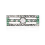 AN EARLY 20TH CENTURY DIAMOND AND EMERALD BROOCH The pierced rectangular plaque centrally set with