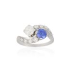 A SAPPHIRE AND DIAMOND 'TOI ET MOI' RING Of crossover design, claw set with a cushion-shaped