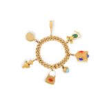 A GOLD CHARM BRACELET The curb-link bracelet chain suspending seven gold charms including a handbag,