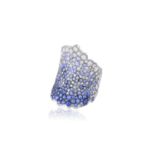 A SAPPHIRE AND DIAMOND 'KANAWAGA' RING, BY JULIE GENET Of scalloped design, set throughout with