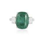 AN EMERALD AND DIAMOND RING The cushion-shaped emerald weighing approximately 6.70cts, between two