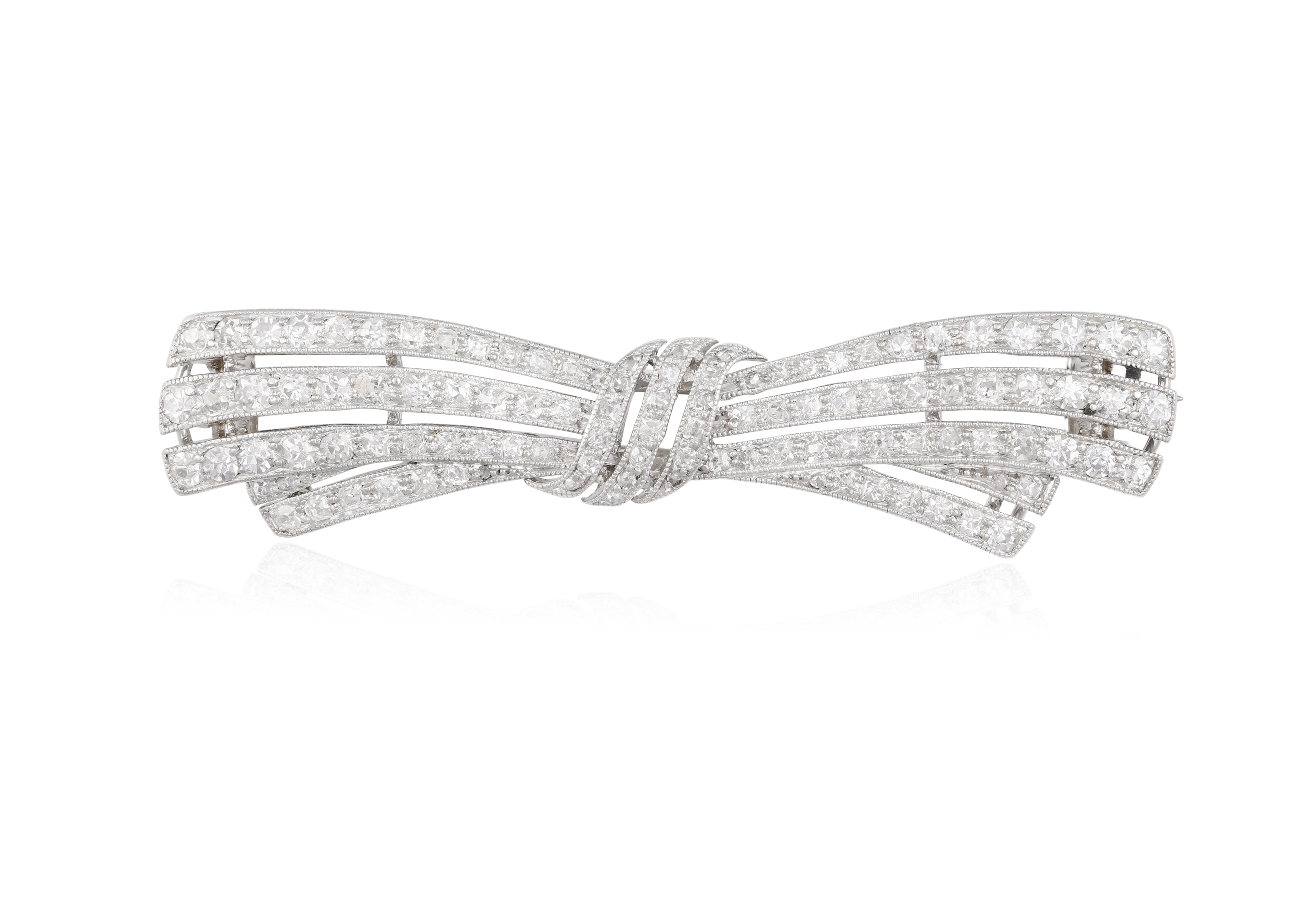AN EARLY 20TH CENTURY DIAMOND BROOCH, CIRCA 1910 The pierced bow millegrain-set throughout with