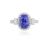 A SAPPHIRE AND DIAMOND RING The oval-shaped sapphire weighing 3.54cts within a brilliant-cut diamond