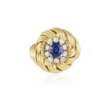 A SAPPHIRE AND DIAMOND COCKTAIL RING, BY BOUCHERON, CIRCA 1960 Of bombé design, the cushion-shaped