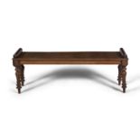 A GEORGE IV MAHOGANY LONG RECTANGULAR HALL BENCH, with double scroll ends, on turned fluted baluster