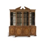 A LARGE EARLY 19TH CENTURY PINE BREAKFRONT BOOKCASE, the central broken triangular pediment with
