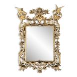 A GEORGE III STYLE CARVED GILTWOOD MIRROR, the Rococo frame with shell and rose cresting, flanked by