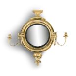 A GEORGE IV GILTWOOD CONVEX GIRANDOLE MIRROR, the circular plate within an ebon slip and leaf