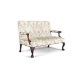 A 19TH CENTURY MAHOGANY FRAMED SETTEE, upholstered in cream fabric with polychrome floral