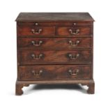 A GEORGE III MAHOGANY CHEST, the plain moulded top above a pull out brushing slide, over two short