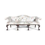 A GEORGIAN STYLE MAHOGANY FRAMED LARGE CAMEL BACK COUCH, covered in floral pattern on off-white
