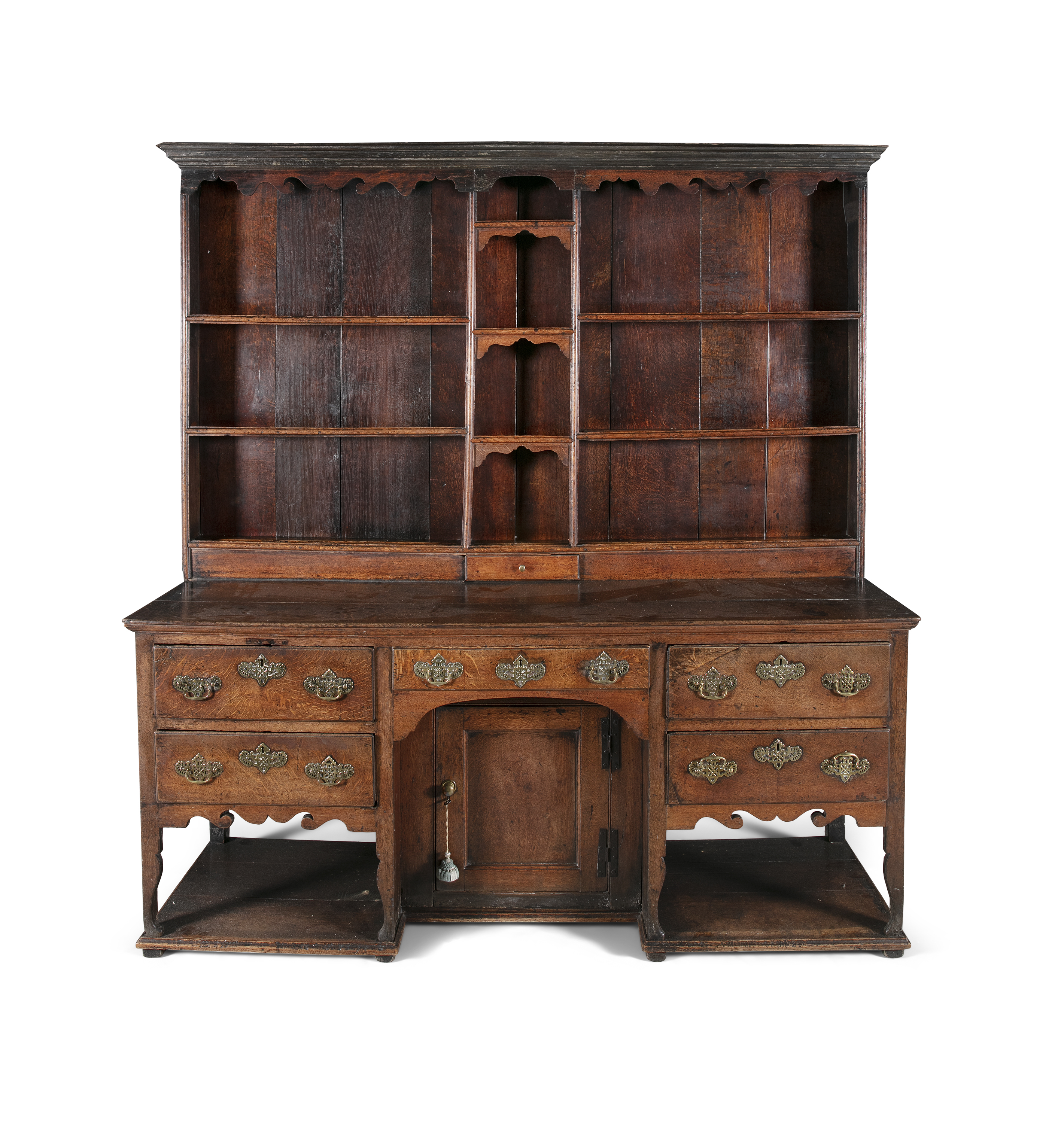 A MID GEORGIAN STAINED OAK WELSH DRESSER, with open shelved back raised on a base, fitted recessed