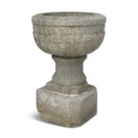 A LARGE EARLY VICTORIAN GRANITE WATER FONT, of deep circular form, the exterior carved with a band