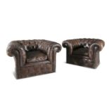 A PAIR OF EARLY 20TH CENTURY TUB BACK CLUB ARMCHAIRS, upholstered in button brown leather, with