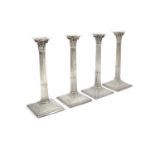 A SET OF FOUR GEORGE III TABLE CANDLESTICKS, by James Allen, London 1767, the Corinthian capitals on