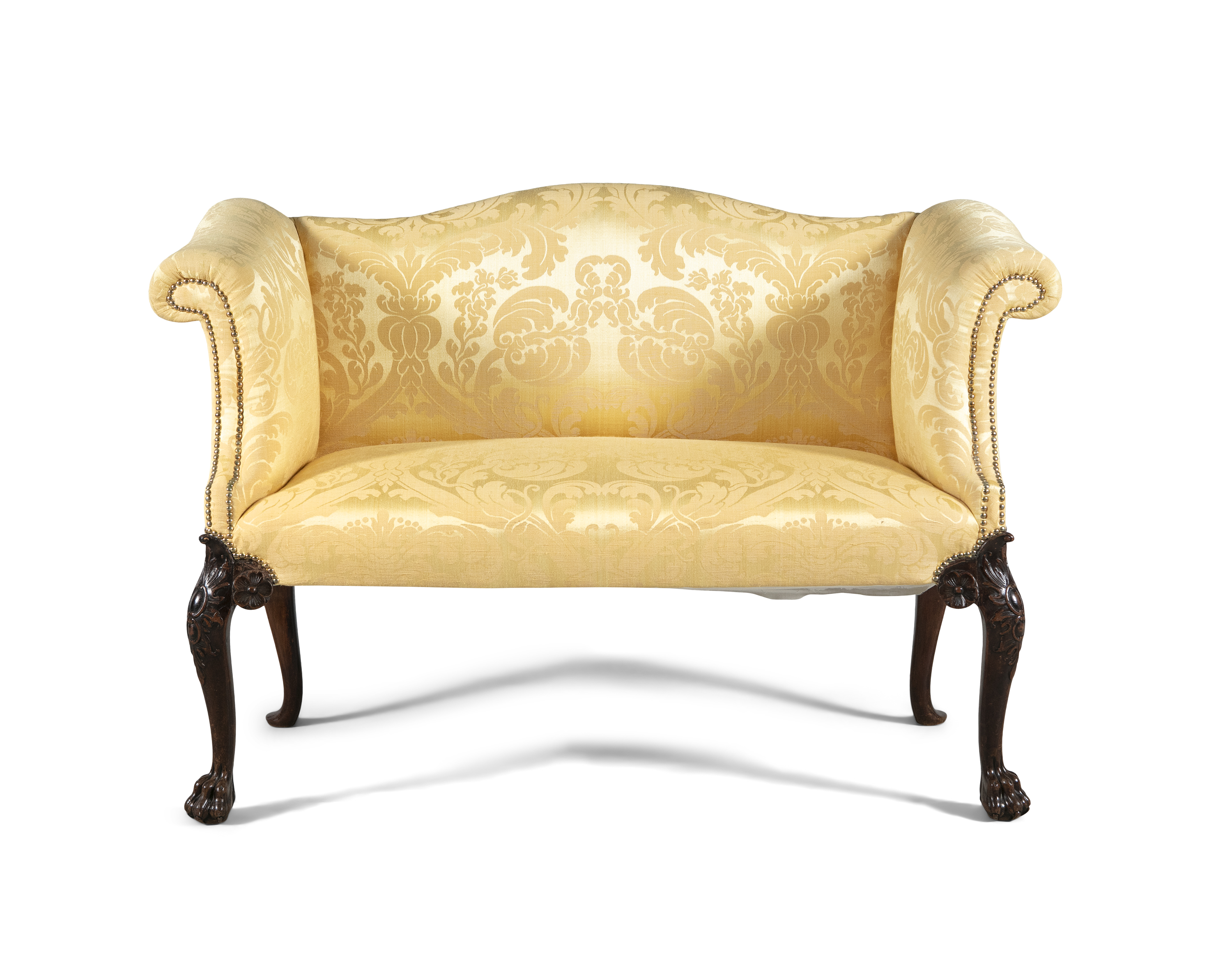 A GEORGE III UPHOLSTERED TWO SEATER SETTEE, with serpentine crest rail and twin scroll ends, covered