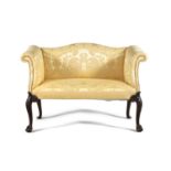 A GEORGE III UPHOLSTERED TWO SEATER SETTEE, with serpentine crest rail and twin scroll ends, covered