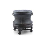A PAIR OF CHINESE BRONZE RAIN DRUMS, 17th/18th century, on fitted stands cast to a waisted