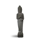 A THAI CARVED STONE BUDDHA, 19th century, modelled standing on square plinth base, dressed in open