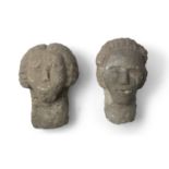 A PAIR OF IRISH CELTIC SANDSTONE HEADS, modelled as a male and female, each carved with pronounced