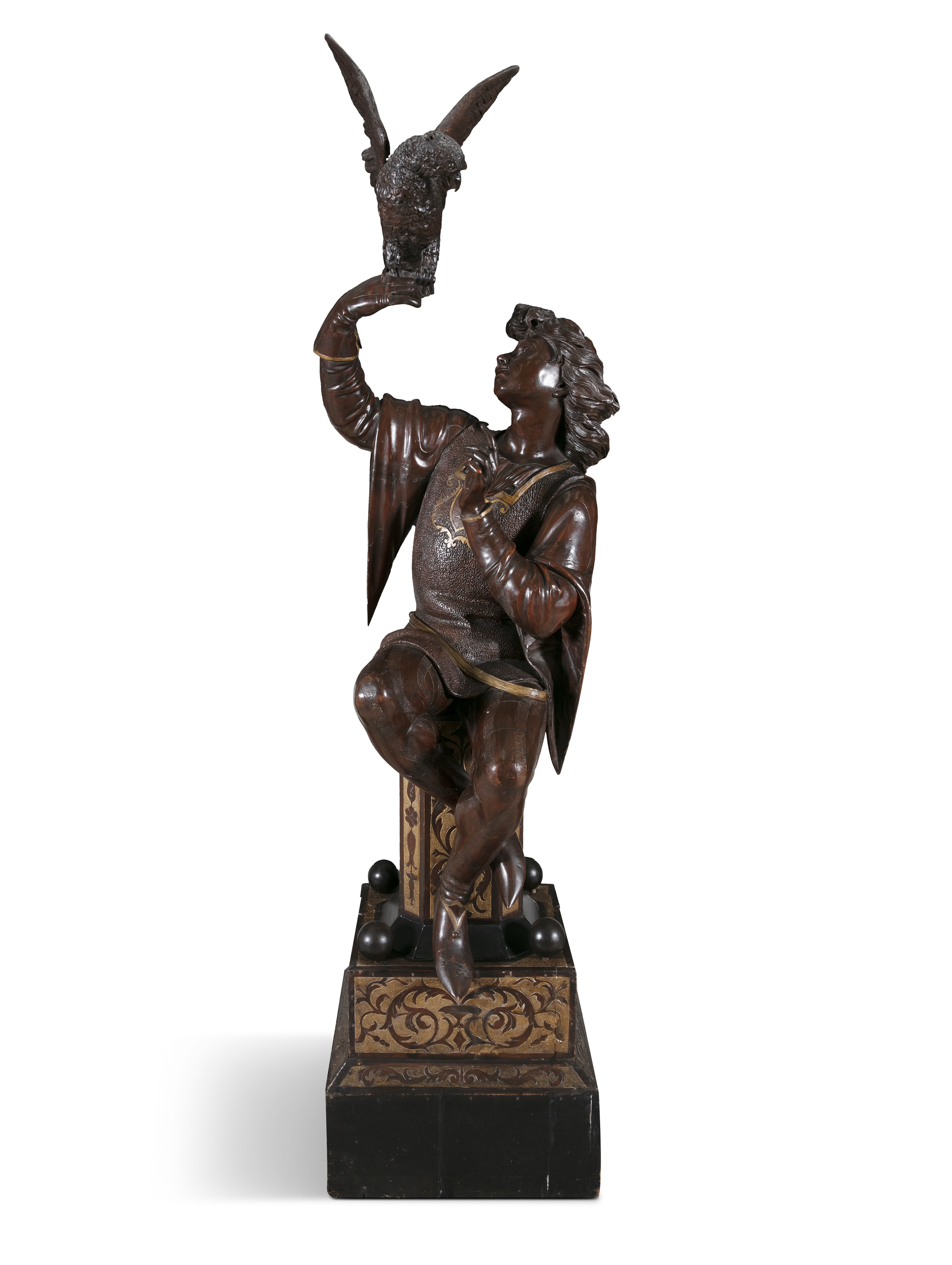 A LARGE FLORENTINE CARVED WALNUT AND PARCEL GILT FIGURE OF A FALCONER, 19th century, in seated
