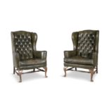 A PAIR OF GEORGE III STYLE MAHOGANY FRAMED WING BACK ARMCHAIRS, upholstered in green button back