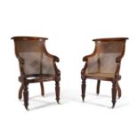 A PAIR OF GEORGE IV MAHOGANY FRAMED TUB BACK BERGERE ARMCHAIRS, with overscrolling crest rail and