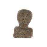 AN ANCIENT CELTIC STONE HEAD, probably 8th - 12th century, the flattened oval face carved with
