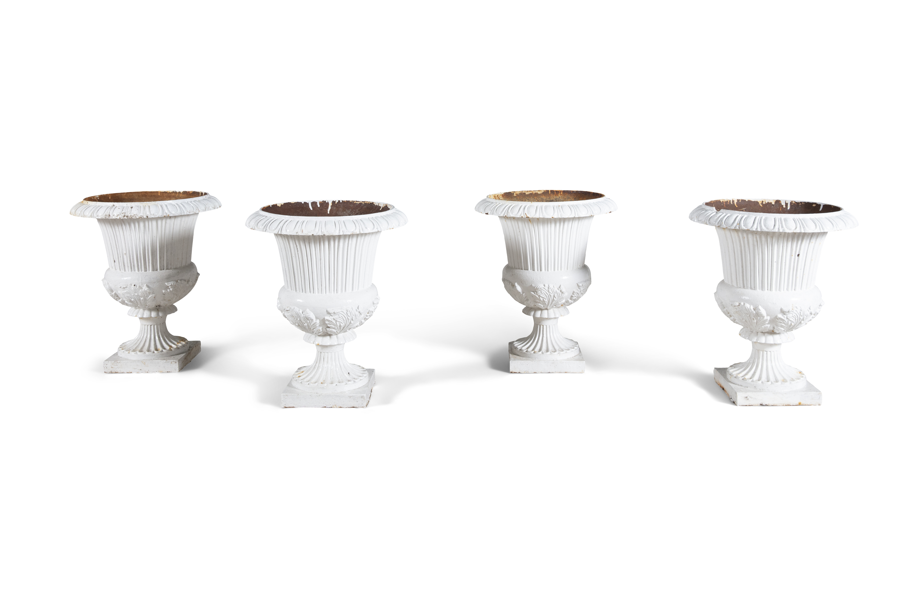 FOUR WHITE PAINTED CAST IRON GARDEN URNS, 19TH CENTURY, of campagna form, each with everted rims,