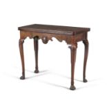 AN IRISH GEORGE III MAHOGANY FOLDING TOP TABLE, the hinged rectangular top above a shaped apron,