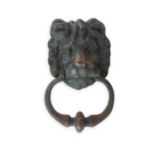 A GEORGIAN BRONZE DOOR KNOCKER IN THE FORM OF A LION MASK, with ring turned knocker. 21 x 13cm