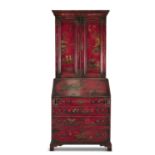 A GEORGE III STYLE RED LACQUERED BUREAU BOOKCASE, the moulded cornice above twin fielded panel doors