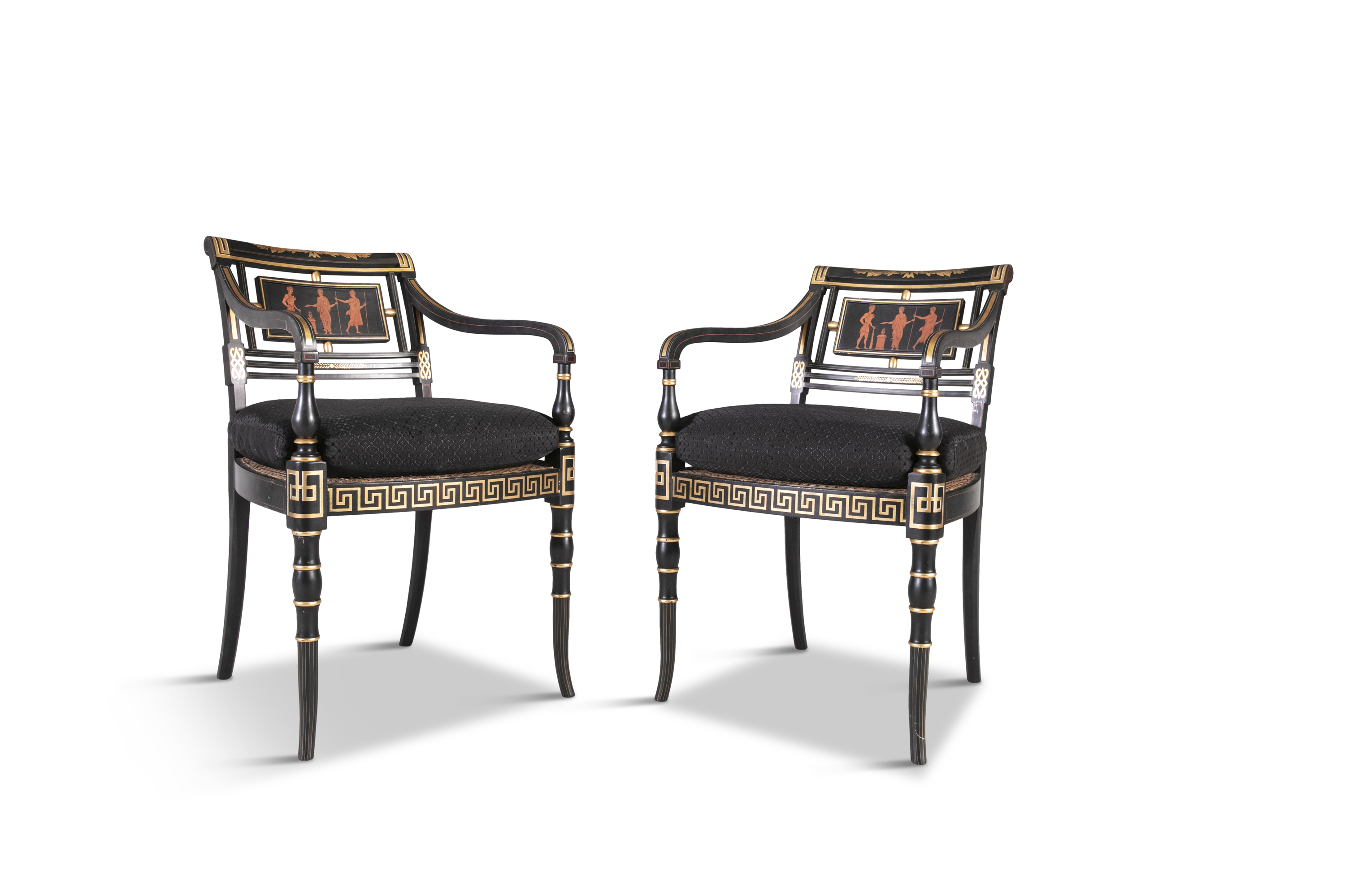 A PAIR OF REGENCY STYLE EBONISED AND PARCEL GILT OPEN ARMCHAIRS, the open backs with central