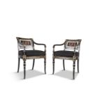 A PAIR OF REGENCY STYLE EBONISED AND PARCEL GILT OPEN ARMCHAIRS, the open backs with central