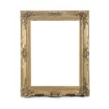 A LARGE ENGLIGH GILTWOOD AND GESSO PICTURE FRAME, C. 1880, of deep rectangular form, with moulded