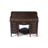 A STAINED WOOD CYLINDER DESK, c.1900, with fitted interior, the cylinder with lock plate signed