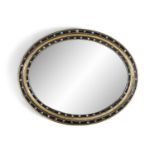 AN IRISH EBONISED AND PARCEL GILT OVAL WALL MIRROR, c.1870, with plain glass plate contained