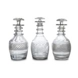A COLLECTION OF THREE IRISH CUT GLASS DECANTERS AND STOPPERS, early 19th century, probably Cork or