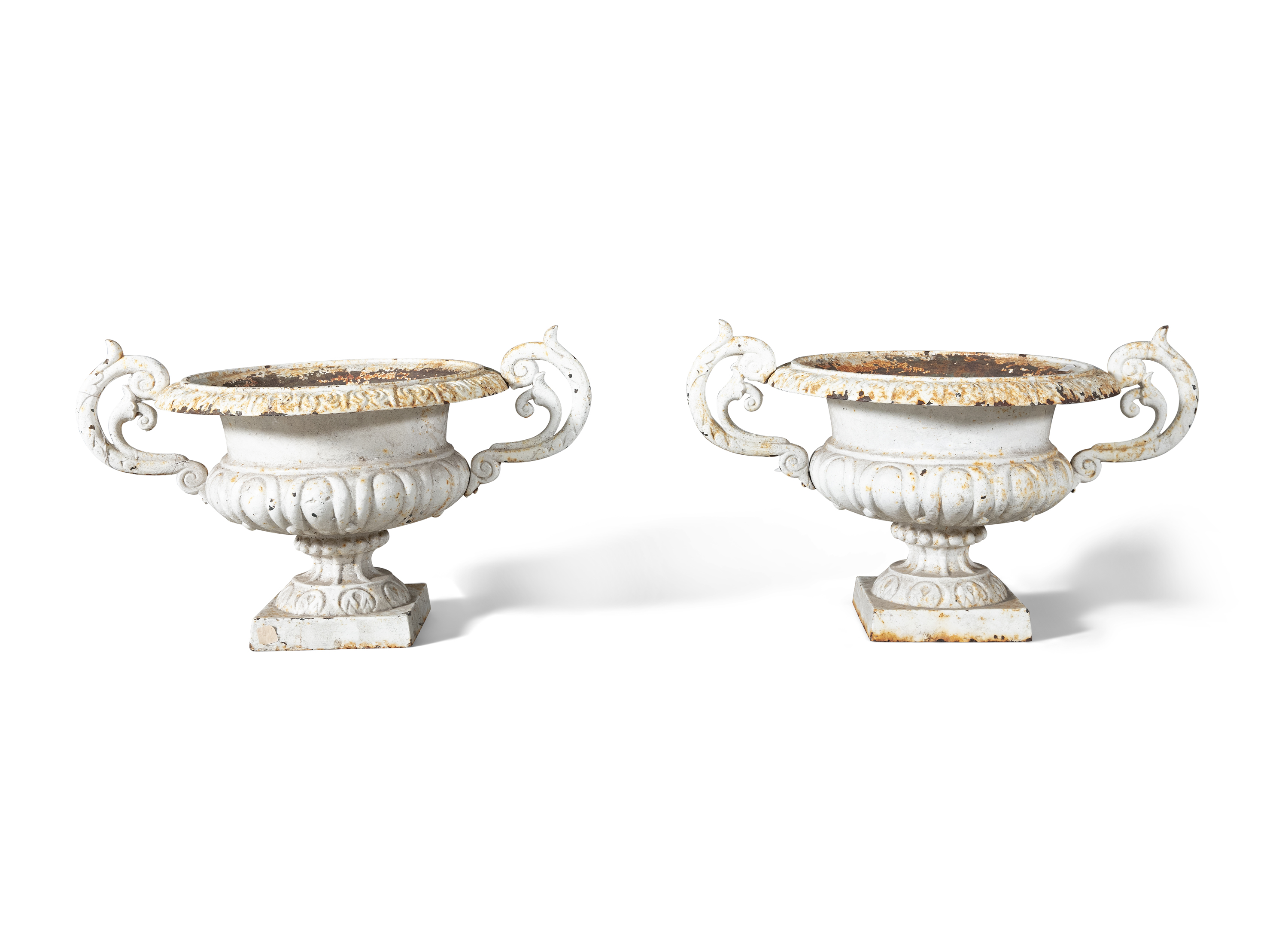 A PAIR OF VICTORIAN CAST IRON GARDEN URNS, each of classical design, with overturned rims and