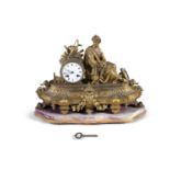 A FRENCH 19TH CENTURY GILT METAL CASED MANTLE CLOCK, the drum case with white enamel dial, flanked