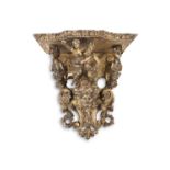 AN ITALIAN BAROQUE CARVED GILTWOOD AND GESSO WALL BRACKET, carved with a central figure of